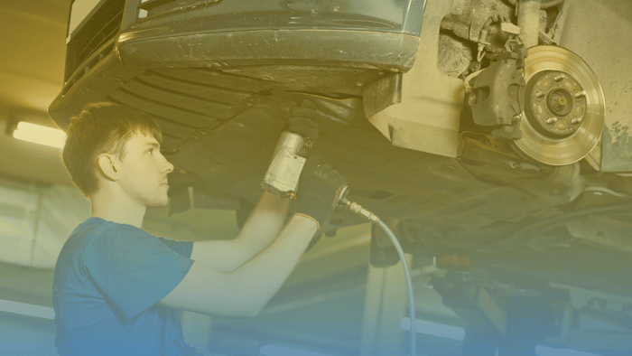 technician working on car on lift 