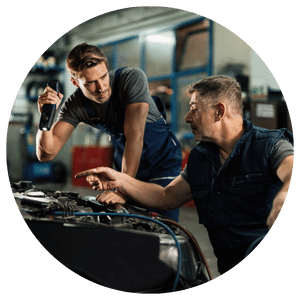 two technicians working on a vehicle