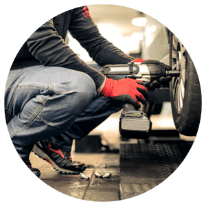 technician putting a tire on a car 