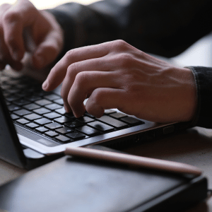 hands typing on laptop keyboard