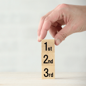 wooden blocks that say first, second, and third place stacked on top of each other
