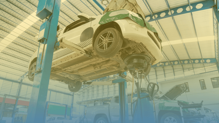 car on a lift in an auto repair shop